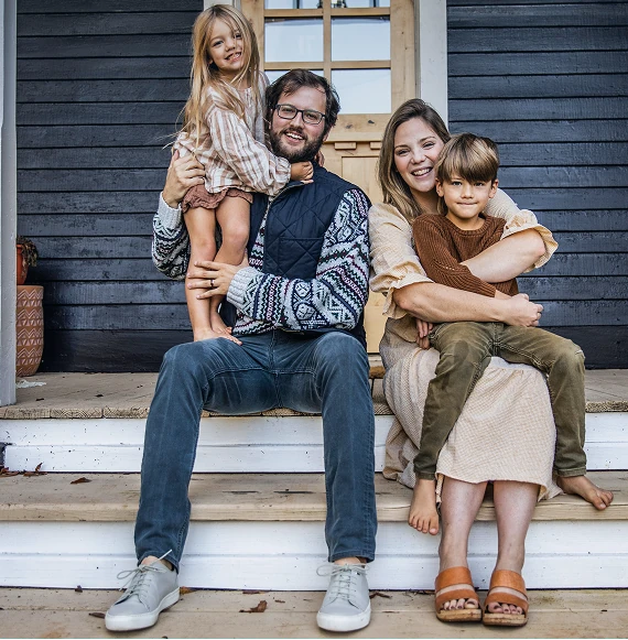family sitting on their front porch