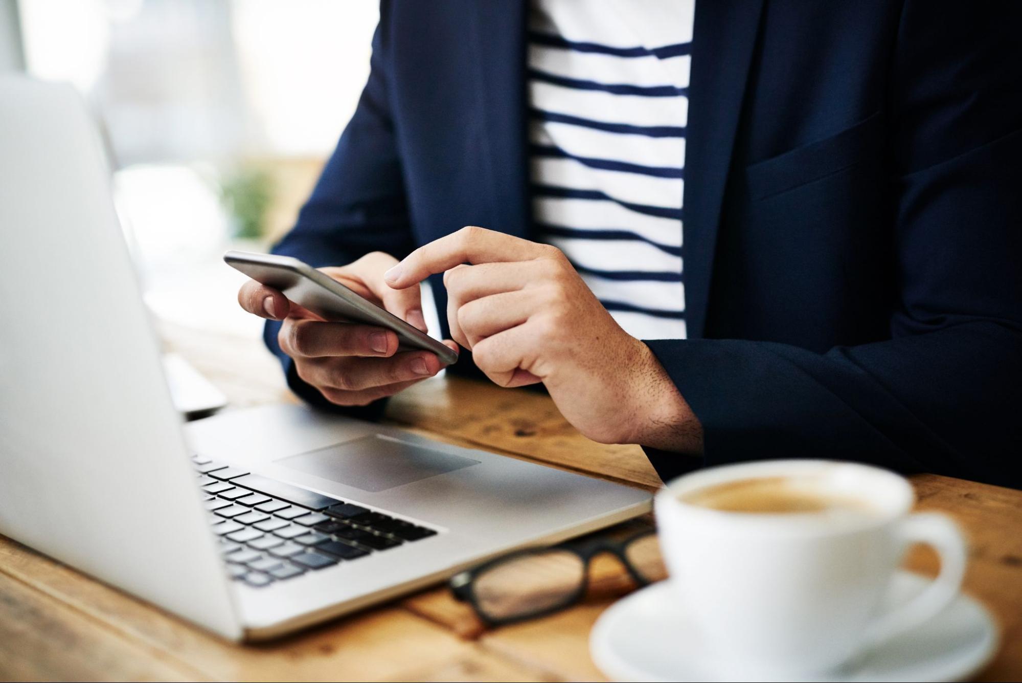 A person used their phone and laptop